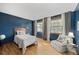 Bedroom with an accent wall, hardwood floors, and two large windows providing lots of natural light at 7563 Lamar Ct, Arvada, CO 80003