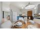Bright dining area adjacent to kitchen, featuring a round table set for four and modern lighting at 7563 Lamar Ct, Arvada, CO 80003
