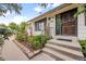 Inviting front entrance with lush landscaping and a secure door at 7563 Lamar Ct, Arvada, CO 80003