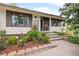 Inviting front entrance with beautiful landscaping, flowers and a secure door at 7563 Lamar Ct, Arvada, CO 80003