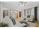 Cozy living room with comfortable seating, light hardwood floors, and plenty of natural light at 7563 Lamar Ct, Arvada, CO 80003
