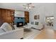 Inviting living room featuring a fireplace with painted brick, wood built-ins, and a cozy seating area at 7563 Lamar Ct, Arvada, CO 80003