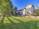 Beautiful backyard featuring lush lawn, mature trees and outdoor entertaining spaces at 11811 Lewiston St, Commerce City, CO 80022