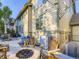 Outdoor patio with a stone fire pit, seating, and a view of the home's exterior at 11811 Lewiston St, Commerce City, CO 80022