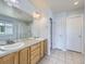 Bright bathroom with dual sinks, large mirror, and tile flooring for a clean, modern look at 11811 Lewiston St, Commerce City, CO 80022