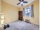 Bedroom with a ceiling fan, a window with sheer curtains, and carpet flooring at 11811 Lewiston St, Commerce City, CO 80022