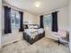 Cozy bedroom with natural light, featuring carpet and a built-in bookcase bed frame at 11811 Lewiston St, Commerce City, CO 80022
