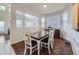 Bright dining room with hardwood floors, a modern table and chairs, and lots of natural light at 11811 Lewiston St, Commerce City, CO 80022