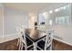 Dining room with hardwood floors and a modern dining table with seating for six, next to the living area at 11811 Lewiston St, Commerce City, CO 80022
