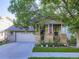 Charming home with a two-car garage, landscaped front yard, and inviting front porch with American flag at 11811 Lewiston St, Commerce City, CO 80022