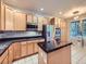 Kitchen featuring stainless steel appliances, wood cabinets, and an island with a black countertop at 11811 Lewiston St, Commerce City, CO 80022