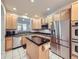 Modern kitchen with stainless steel appliances, black countertops and center island at 11811 Lewiston St, Commerce City, CO 80022