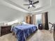 Spacious main bedroom with tray ceiling, side tables, dresser, and a window at 11811 Lewiston St, Commerce City, CO 80022