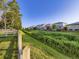 Scenic view of neighborhood homes bordering a grassy greenbelt with a wooden fence at 11811 Lewiston St, Commerce City, CO 80022