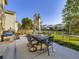 Outdoor patio with dining set, fire pit, and well-manicured lawn for entertainment at 11811 Lewiston St, Commerce City, CO 80022