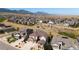 Aerial view of homes in a neighborhood surrounded by open space and mountains at 19475 W 94Th Ave, Arvada, CO 80007