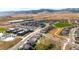 Aerial view of a residential area with a community pool, school, and open spaces at 19475 W 94Th Ave, Arvada, CO 80007