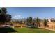 Landscaped backyard with a trampoline, grass, and mountain views at 19475 W 94Th Ave, Arvada, CO 80007