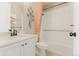 Bathroom showcasing vanity, shower/tub combination with an orange decorative shower curtain, and modern hardware at 19475 W 94Th Ave, Arvada, CO 80007