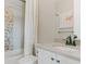 Bathroom featuring white vanity, mosaic shower tiles, and neutral decor for a clean aesthetic at 19475 W 94Th Ave, Arvada, CO 80007