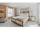 A bright bedroom with a decorative headboard and stylish furnishings at 19475 W 94Th Ave, Arvada, CO 80007