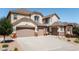 Exterior elevation of a home with three-car garage and well-maintained landscaping at 19475 W 94Th Ave, Arvada, CO 80007