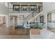 Bright, open foyer with a staircase and wrought iron railing leading to the second level at 19475 W 94Th Ave, Arvada, CO 80007