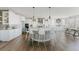 Bright and airy kitchen with white cabinets, an island with bar seating, and modern stainless steel appliances at 19475 W 94Th Ave, Arvada, CO 80007