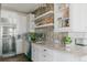 Modern kitchen featuring white cabinets, granite countertops, and stylish backsplash at 19475 W 94Th Ave, Arvada, CO 80007