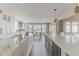 Bright, open kitchen with a large island, sleek countertops, and views of the outdoors at 19475 W 94Th Ave, Arvada, CO 80007