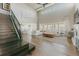 Spacious living room featuring a soaring ceiling, large windows, hardwood floors, and staircase access at 19475 W 94Th Ave, Arvada, CO 80007