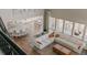 Aerial view of an open concept living room featuring a large white sofa and lots of windows at 19475 W 94Th Ave, Arvada, CO 80007