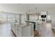 Open-concept living space with kitchen island, dining area, fireplace, and access to patio at 19475 W 94Th Ave, Arvada, CO 80007