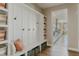 Organized mudroom with storage, seating, and access to the kitchen at 19475 W 94Th Ave, Arvada, CO 80007