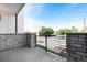 Balcony with stone pillars, a black metal railing, and views of the surrounding neighborhood at 2076 S Holly St # 1, Denver, CO 80222