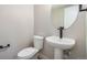 Bathroom featuring a modern pedestal sink, a toilet, and clean, neutral finishes at 2076 S Holly St # 1, Denver, CO 80222