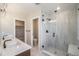 Bathroom featuring double sinks, a glass shower, and modern finishes at 2076 S Holly St # 1, Denver, CO 80222