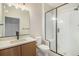 Well-lit bathroom with modern fixtures, vanity, shower, and tile flooring at 2076 S Holly St # 1, Denver, CO 80222