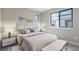 Bright bedroom with large window, modern decor, and plush carpeting creates a relaxing atmosphere at 2076 S Holly St # 1, Denver, CO 80222