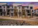Modern townhome exterior with stone accents, black trim, and professional landscaping at 2076 S Holly St # 1, Denver, CO 80222
