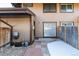 Back yard view with patio and partial snow cover at 3742 S Granby Way, Aurora, CO 80014