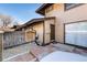 View of the back of a house with a fenced yard and brick patio at 3742 S Granby Way, Aurora, CO 80014