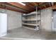 Basement storage area with shelving and open ceiling at 3742 S Granby Way, Aurora, CO 80014