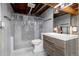 Basement bathroom features a modern vanity and shower with exposed ceiling beams at 3742 S Granby Way, Aurora, CO 80014