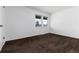 Another bedroom shot, featuring dark brown carpet, neutral walls, and a window in the background at 3742 S Granby Way, Aurora, CO 80014