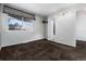 View of bedroom with dark brown carpet and a window, next to a door leading to an ensuite bathroom at 3742 S Granby Way, Aurora, CO 80014