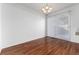 Spacious dining area featuring gleaming hardwood floors and a modern light fixture at 3742 S Granby Way, Aurora, CO 80014