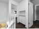 Hallway featuring white paint, dark brown carpet, and several built-in cabinets for storage at 3742 S Granby Way, Aurora, CO 80014