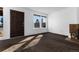 Inviting living room featuring a dark wooden front door and an abundance of natural light at 3742 S Granby Way, Aurora, CO 80014