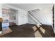 Open-concept living room with staircase, seamlessly connecting to the kitchen for modern living at 3742 S Granby Way, Aurora, CO 80014